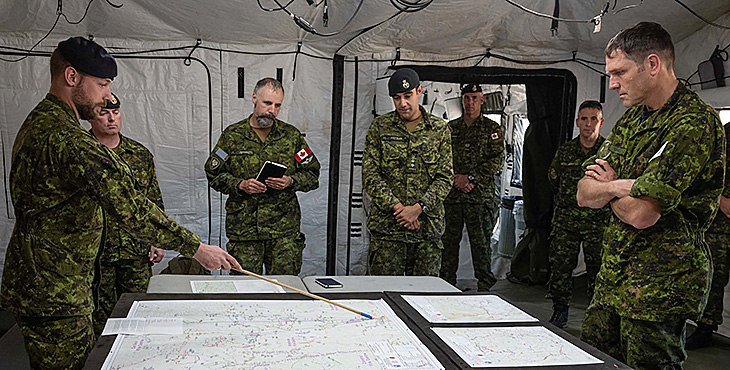 Rear-Admiral Angus Topshee, Commander Maritime Forces Pacific and Joint Task Force Pacific, attends a situational briefing from Land Task Force (LTF) 21-04 and Air Task Force (ATF) 21-04 members about the ongoing Operation LENTUS 21-04, at YKA Kamloops Airport, British Columbia on August 11 2021.