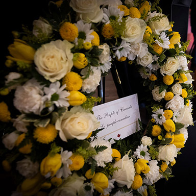 A wreath made of yellow and white flowers.